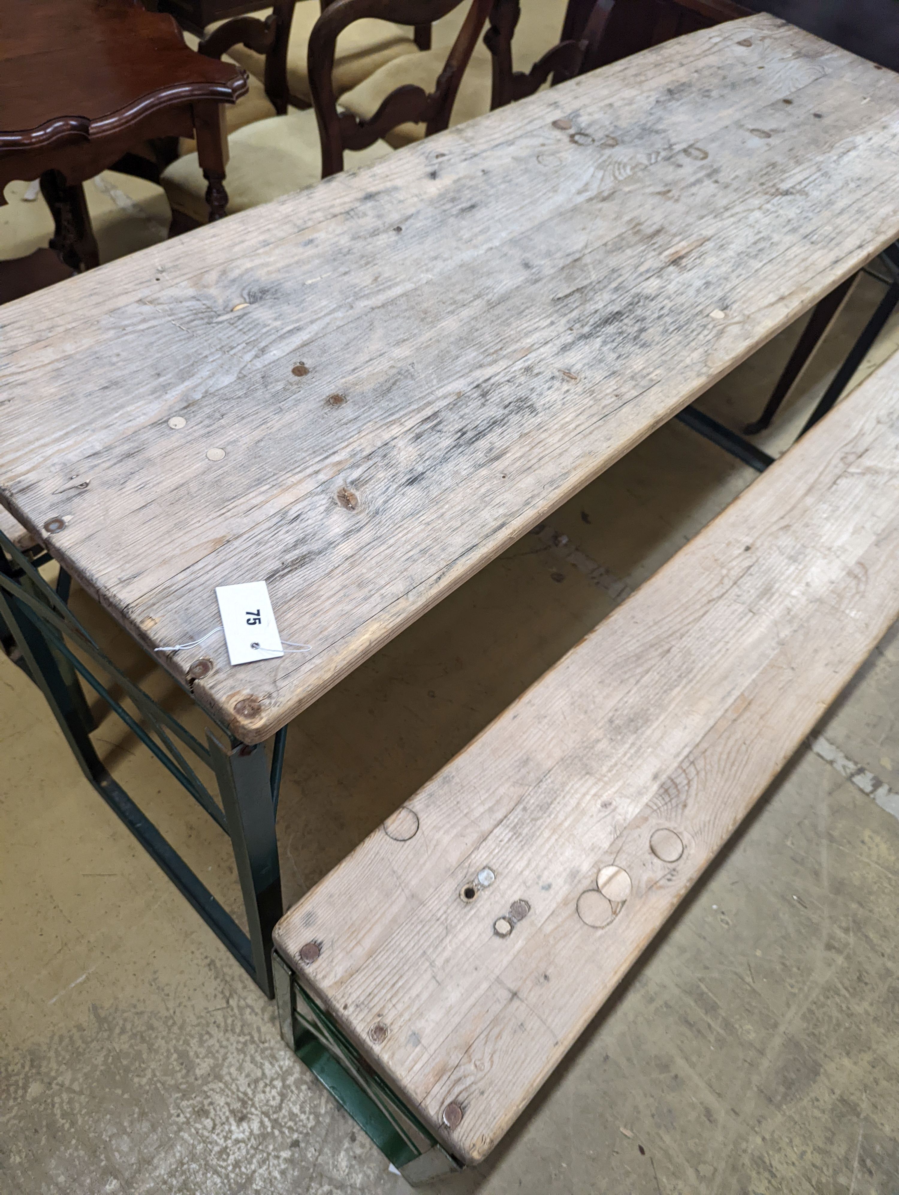 A rectangular pine and painted wrought iron folding garden trestle table, length 150cm, depth 50cm, height 78cm and a pair of matching bench seats